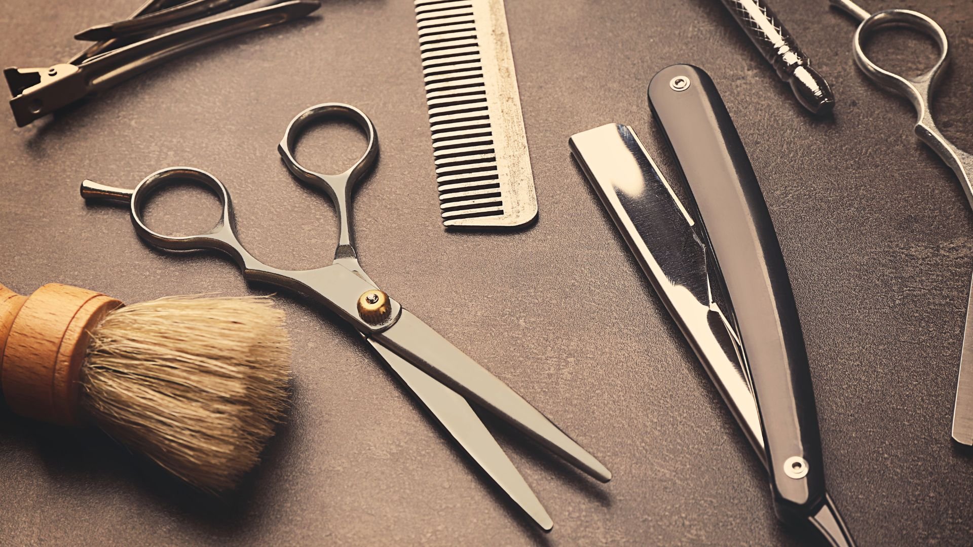Barber tools including scissors, comb, shaving brush, and straight razor
