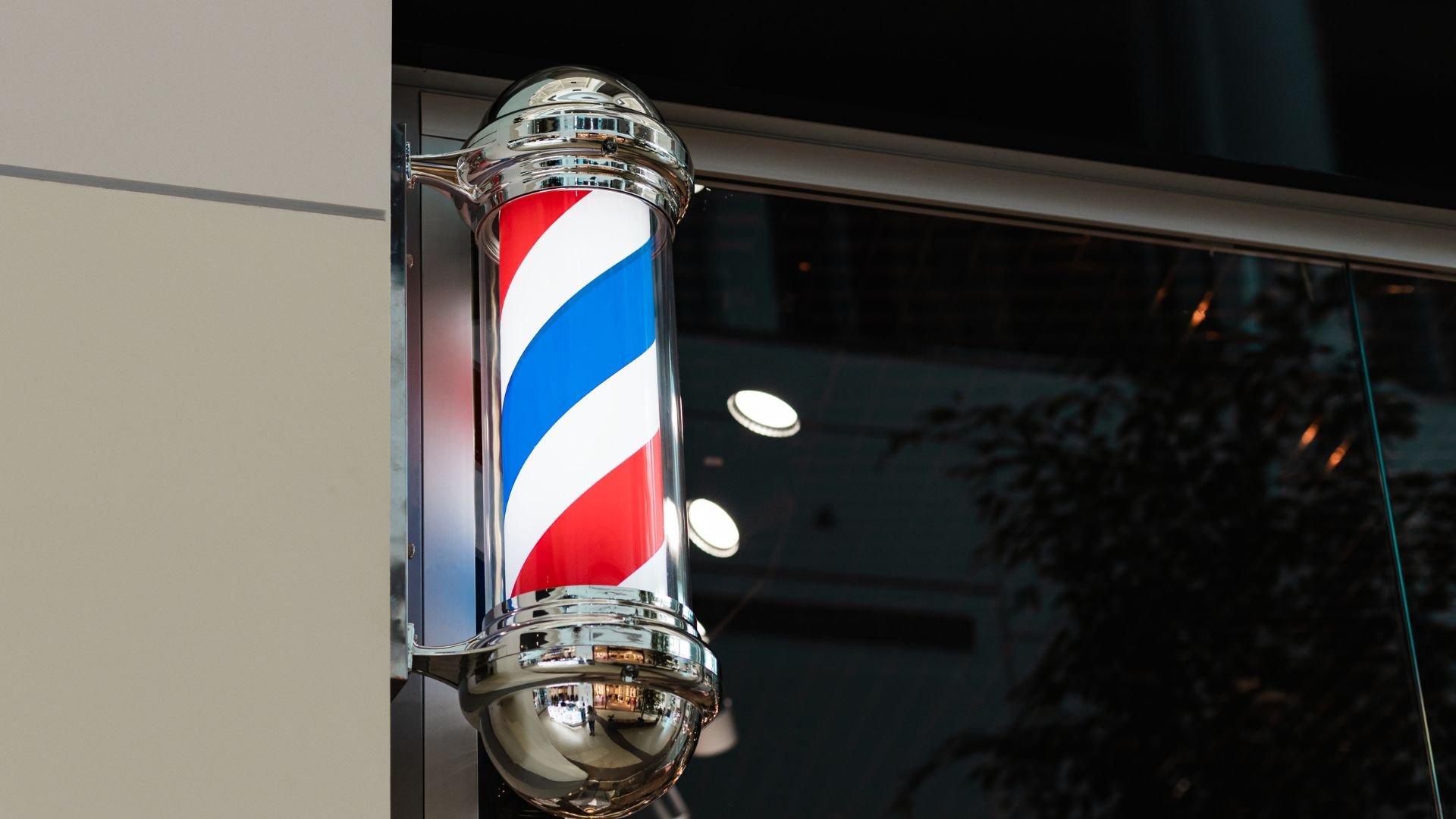 Classic red, white, and blue barber pole with chrome ends