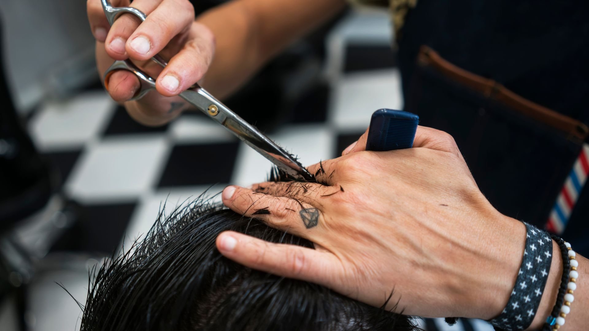 Hairstylist cutting hair with scissors in a professional salon